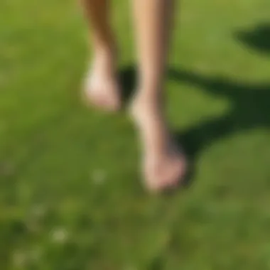 Person walking barefoot on grass